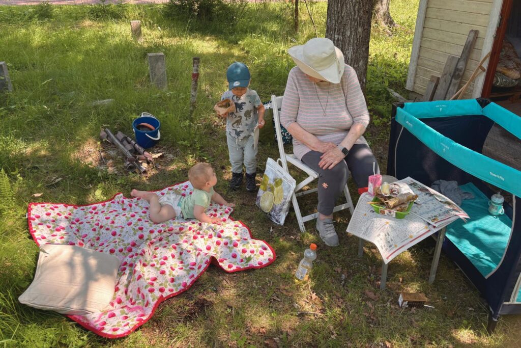 Picnic lunch in the shade of an oak tree at a Finnish cottage during renovation